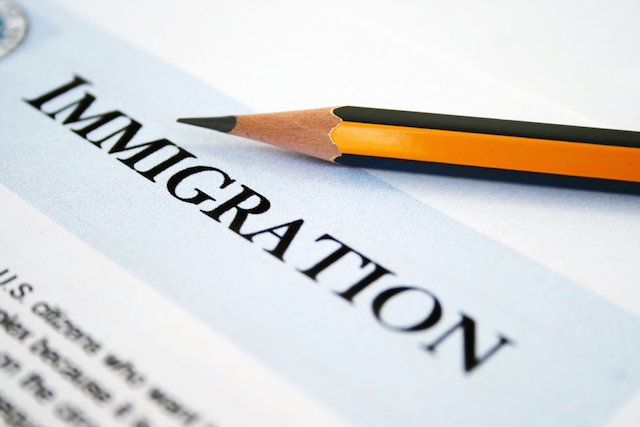 document that says immigration with a pencil on top of it